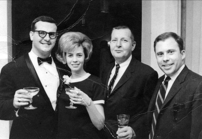 Mom says: “This was a wedding and the man on my right did kill himself. What a loss that was. He couldn't give up the booze. The man on my left was the VP of Burgoyne Index, a company that did consumer research. Your dad worked there with these men. I don't remember the man's name on the end. These were some good times back in the 60's. I was a free woman and enjoying it for all it was worth.”